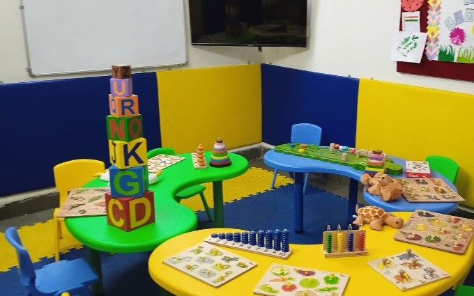 Preschool classroom with child-size furniture and learning aids